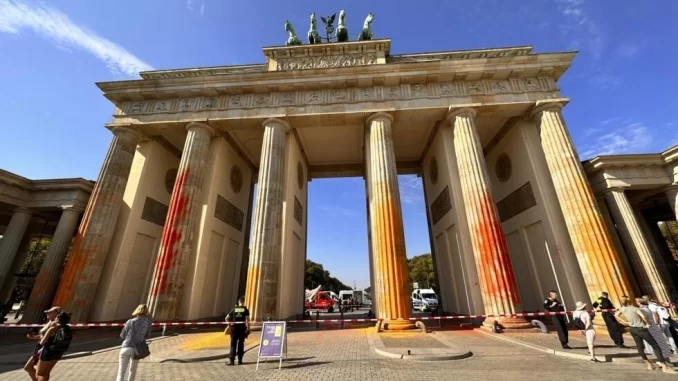 Miembros del movimiento Última Generación rociaron la Puerta de Brandeburgo con pintura naranja en Berlín. © Paul Zinken, AP